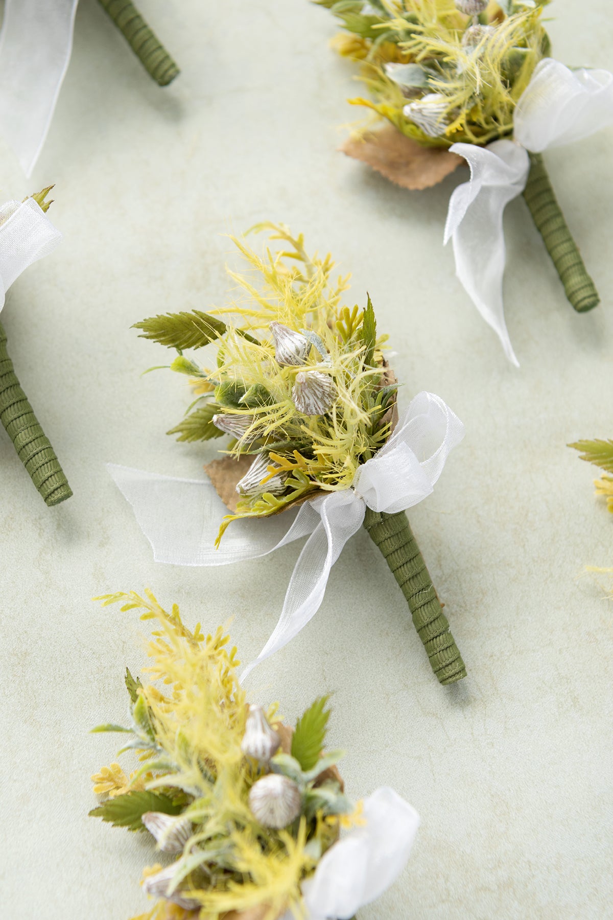 Boutonnieres for Guests in Emerald & Tawny Beige